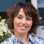 Smiling woman with a wavy, dark bob